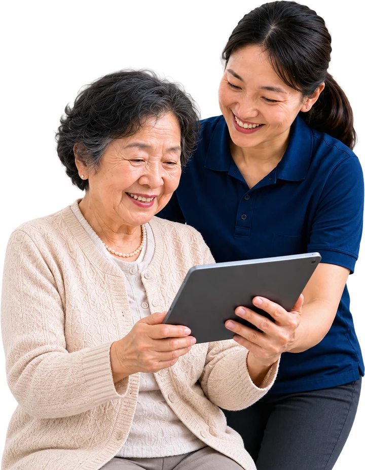 An older Asian woman and a care professional reading her care plan together on a tablet